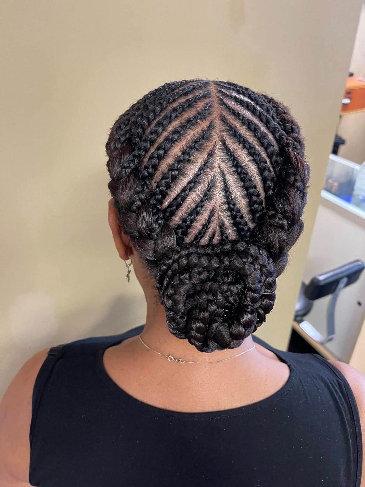 Back view of cornrow braided hairstyle with bundled bun at nape