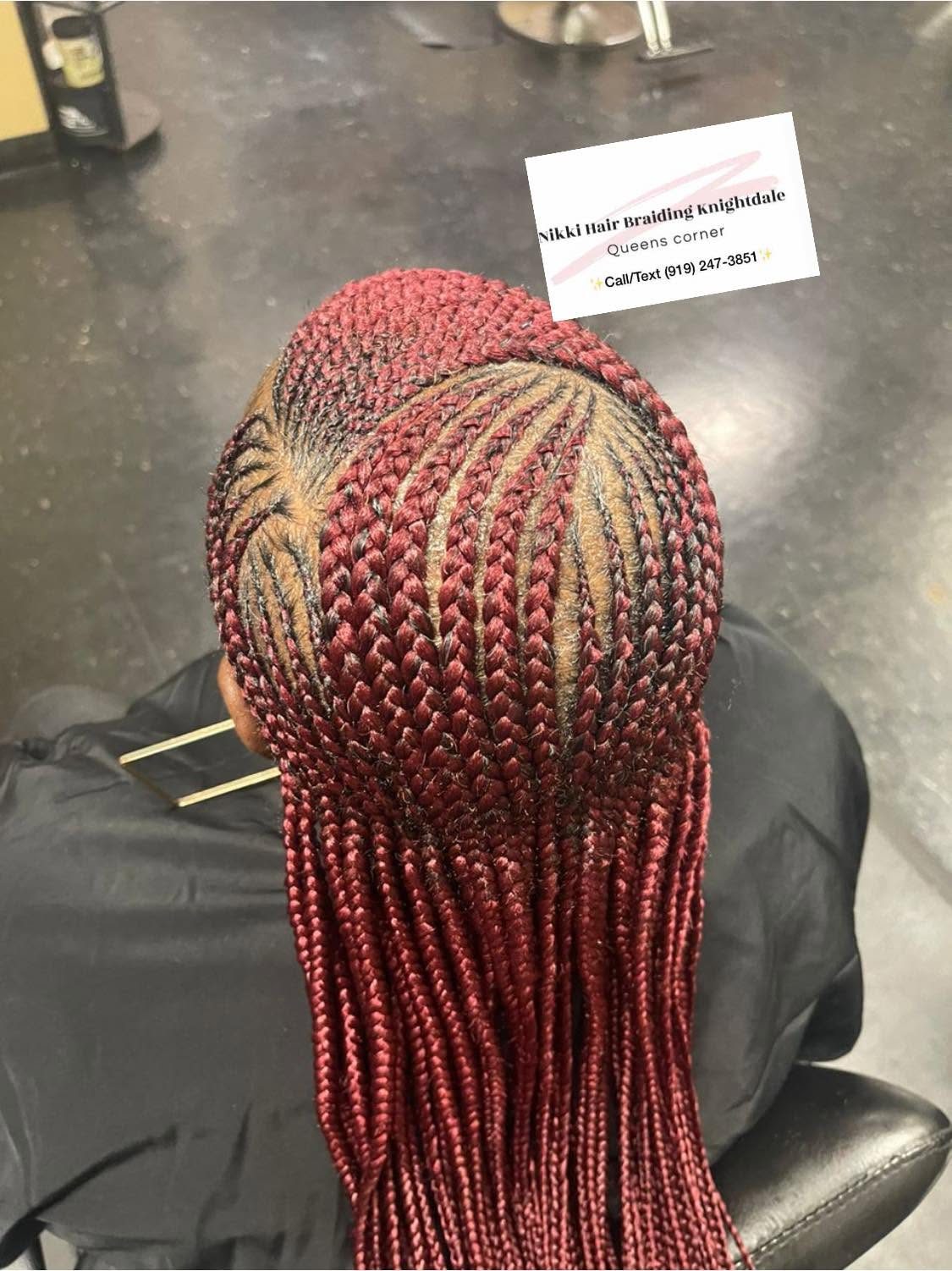 Back view of burgundy braids with gold accent streaks on scalp display head