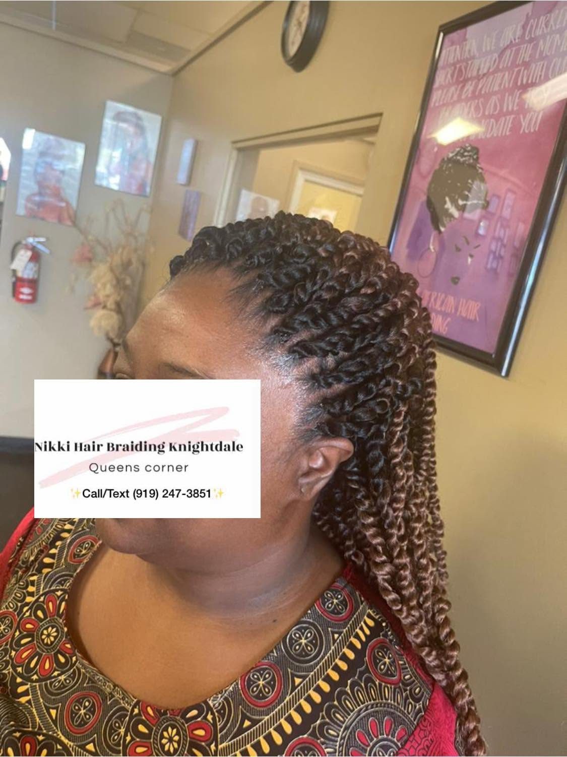 Woman displaying long braided hairstyle in salon setting with contact information overlay