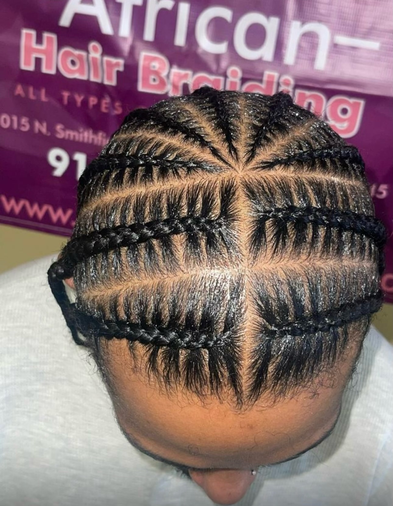 Back view of cornrow braids styled in geometric patterns on a person's head