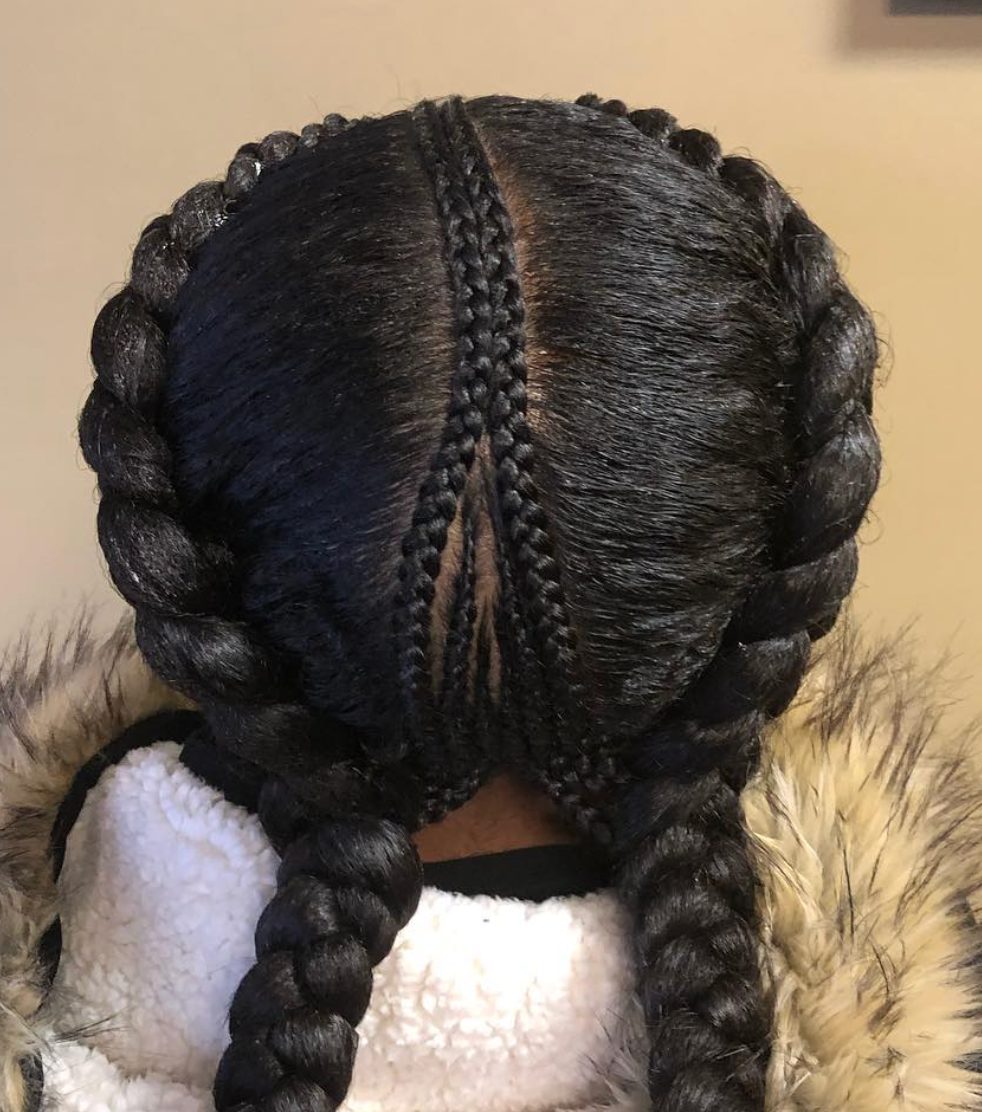 Back view of black braided hairstyle with center part and twisted details